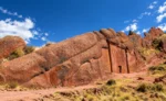 Aramu Muru portal carved in red rock, Ruta Aymara near Puno