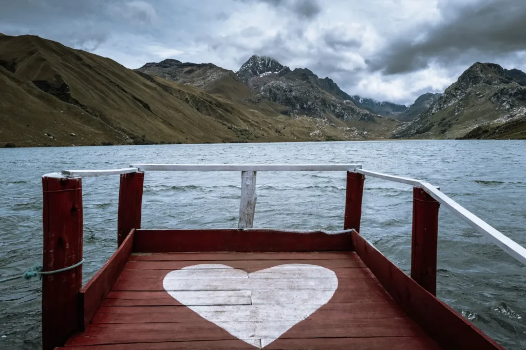 Wooden dock with a painted heart on a lake in the Peruvian Andes
