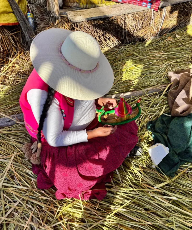 Uros woman crafting on a floating island, Lake Titicaca